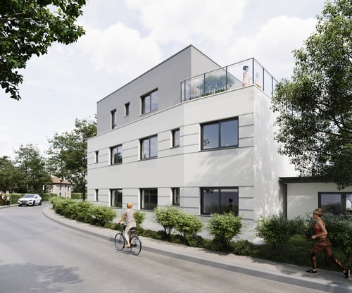Modernes Mehrfamilienhaus mit Flachdach, Dachterrasse und grauer Fassade an einer Straße mit Bäumen und Büschen.