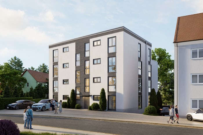 Modernes, weißes Wohnhaus mit dunklen Akzenten und vielen Fenstern an einer Straße; Personen gehen vorbei.